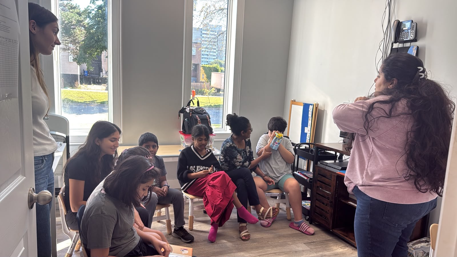 Children and adults gathered in a bright room at the clinic