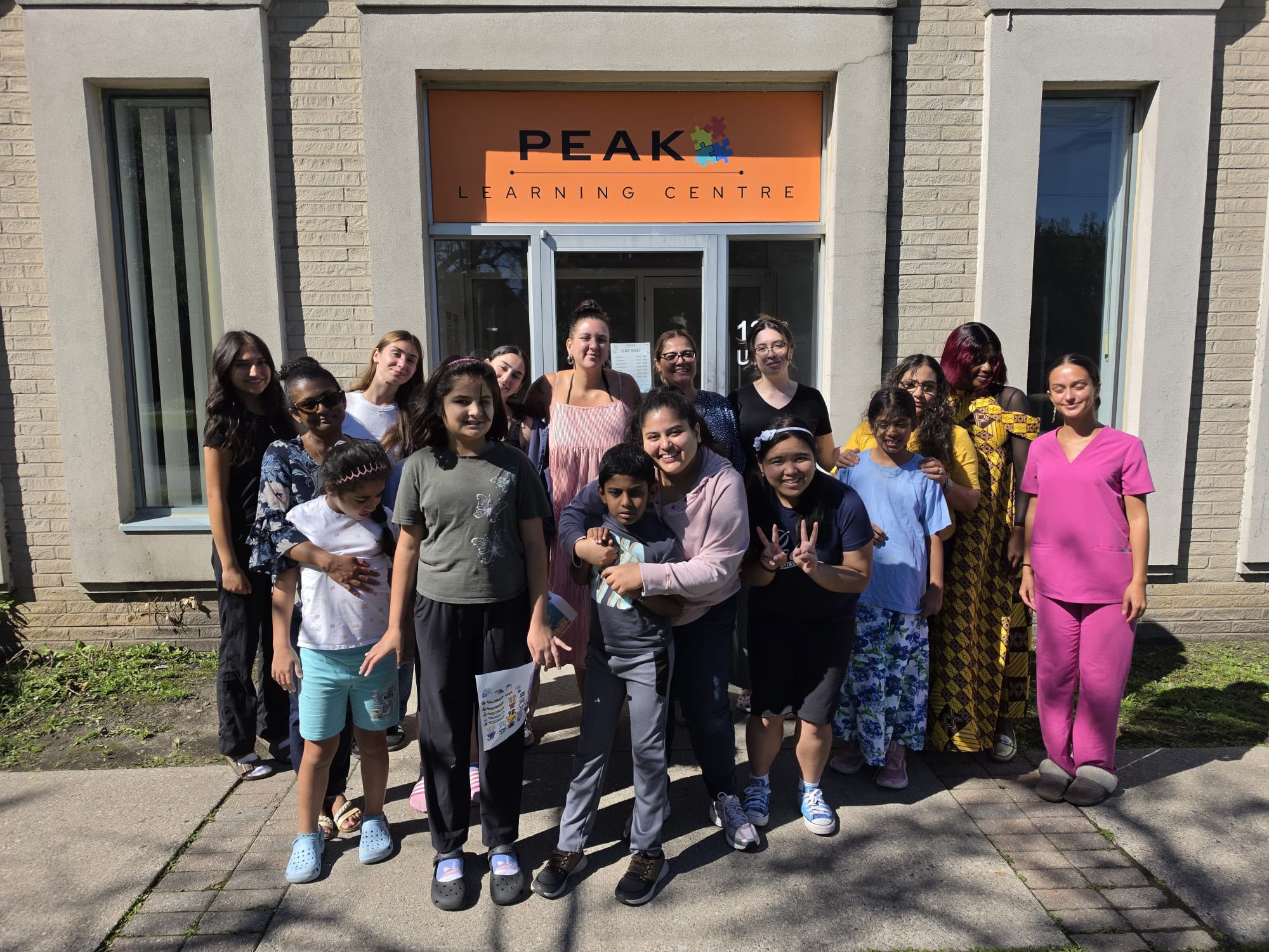 Children and adults gathered outside the Peak Learning Centre entrance