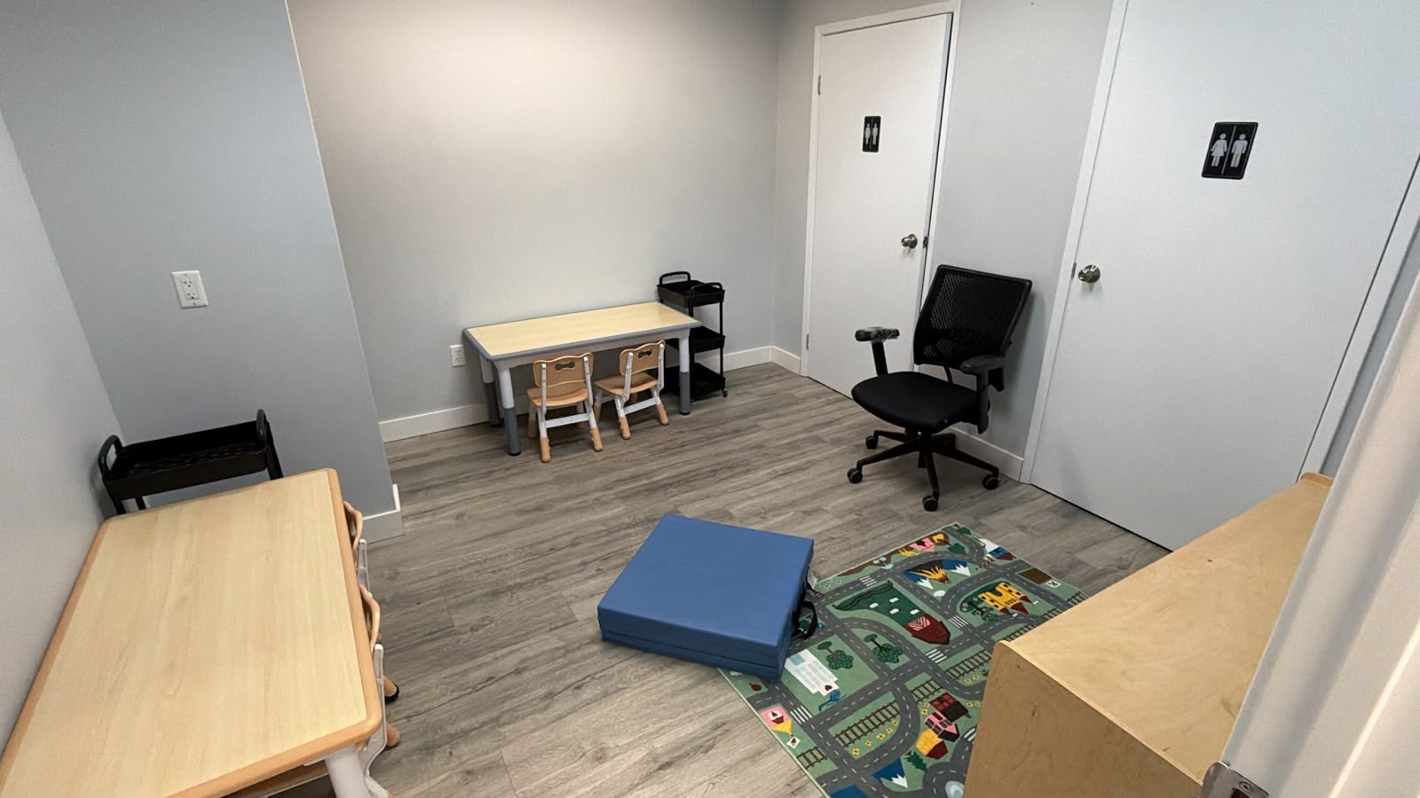 Individual learning space with child-sized desks, a chair and floor mats