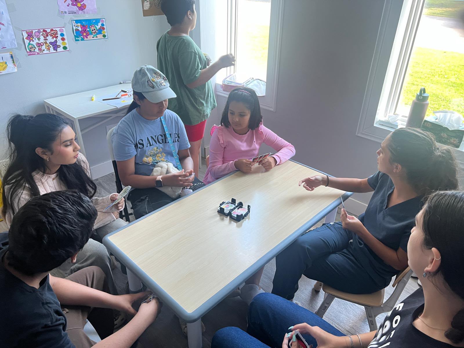 Children and adults taking part in a table activity in the clinic
